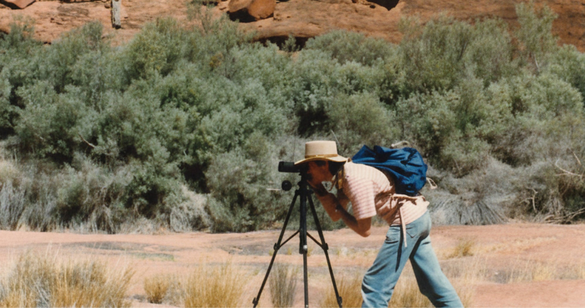 Ian White with a camera on a tripod in a desert landscape